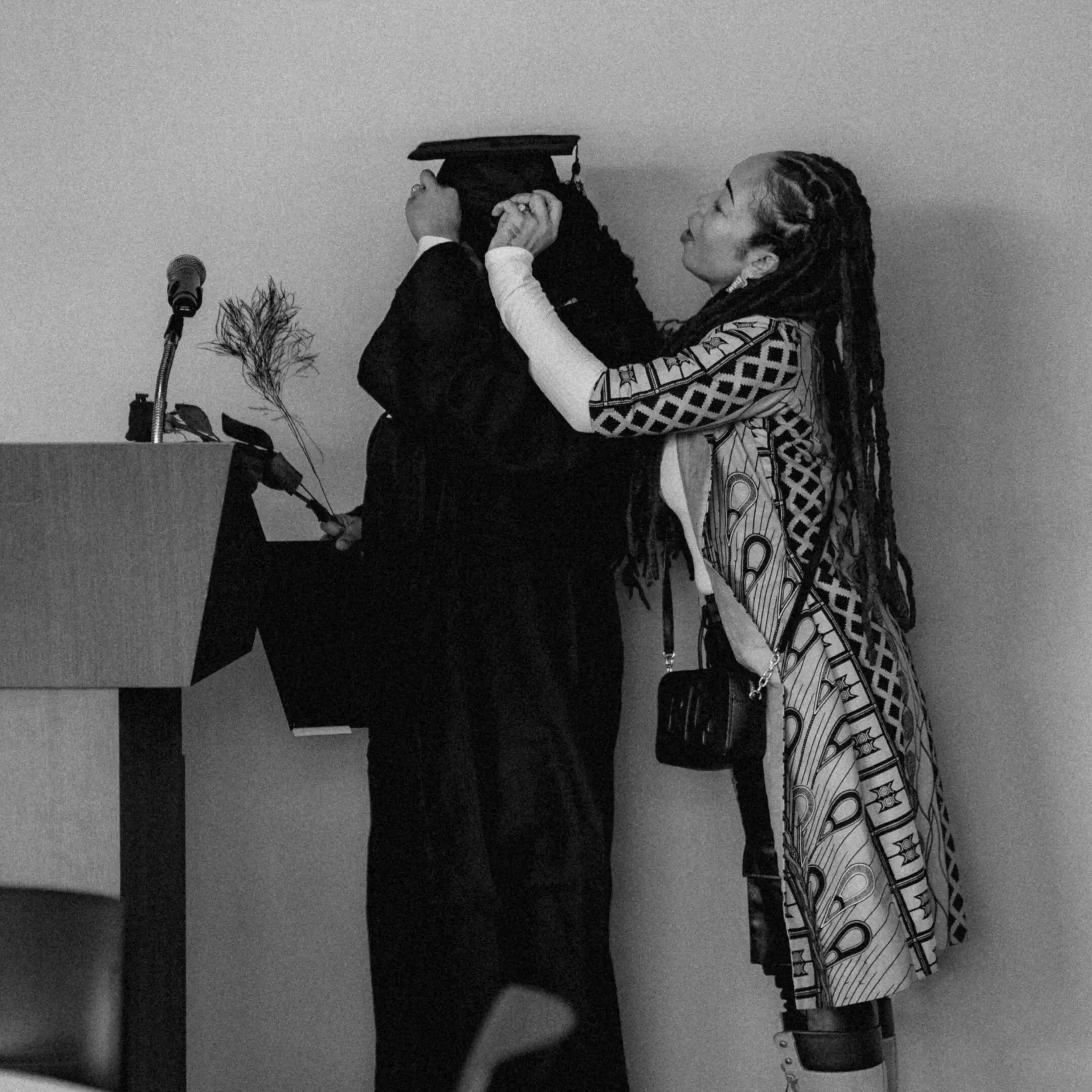 A woman putting on her graduation cap